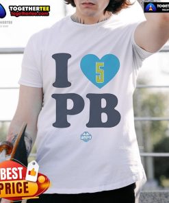 Happy Paige Bueckers wearing a 'I Love Pb' Dallas Wings T-shirt, showcasing her support for the WNBA team.
