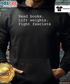 Person wearing a 'Happy Read Books Lift Weights Fight Fascists' hoodie, promoting literacy and activism.
