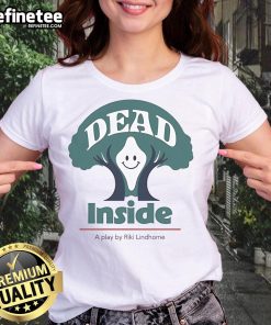 Riki Lindhome in 'Dead Inside' play, wearing a ladies tee, showcasing a happy expression on stage.
