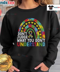 Autism Awareness sweatshirt featuring a rainbow puzzle piece and the phrase 'Don't Judge What You Don't Understand.'
