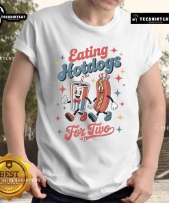 Couple wearing 'Nice Eating Hotdogs For Two' T-Shirt, enjoying hotdogs at a picnic, perfect for food lovers.