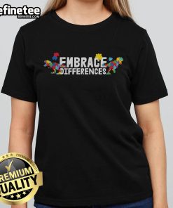 Colorful 'Nice Embrace Differences' autism awareness puzzle dinosaur graphic on a ladies tee shirt, promoting inclusivity.