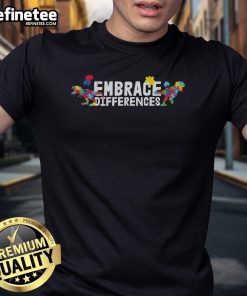Colorful autism awareness puzzle dinosaur T-shirt with 'Embrace Differences' slogan promoting acceptance and inclusion.