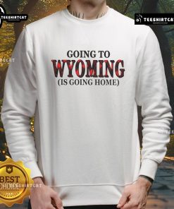 Cozy 'Going to Wyoming is Going Home' sweatshirt in scenic outdoor setting, perfect for travel lovers and Wyoming enthusiasts.