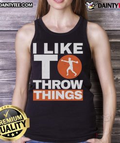 Disc thrower in a tank top during a track and field event, showcasing strength and technique in the discus throw.