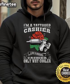 Alt Text: Tattooed cashier wearing a cool hoodie, showcasing a unique style that stands out in a typical retail environment.