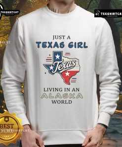 Cozy sweatshirt featuring 'Just a Texas Girl Living in an Alaska World' design, perfect for stylish comfort in colder climates.
