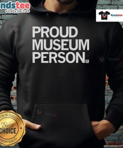 Proud museum staff member wearing a cozy hoodie, showcasing a friendly smile and passion for art and culture.