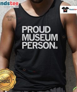 Friendly museum staff member in a tank top proudly showcasing exhibits at a vibrant art museum.