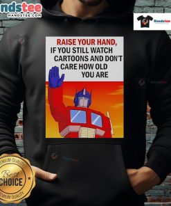 Person wearing a Transformers cartoon hoodie, raising their hand, showcasing love for cartoons regardless of age.