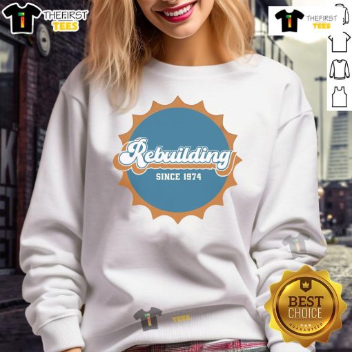 Vintage Nice Rebuilding Since 1974 Dolphins Logo Sweatshirt, perfect for fans of retro sports apparel and Miami Dolphins pride.