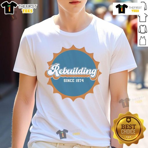 Nice Rebuilding Since 1974 Dolphins Logo T-Shirt featuring the classic Miami Dolphins logo in vibrant colors.