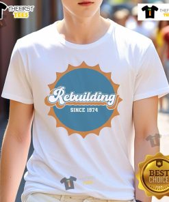 Nice Rebuilding Since 1974 Dolphins Logo T-Shirt featuring the classic Miami Dolphins logo in vibrant colors.