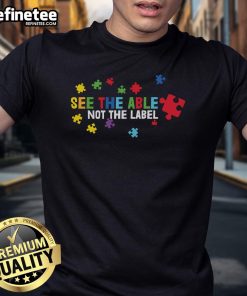 Colorful puzzle piece T-shirt with 'See The Able Not The Label' slogan for Autism Awareness.