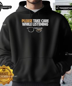 Person wearing a hoodie and glasses, listening intently to 'Nice Tenderfoot TV True Crime' podcast episode.