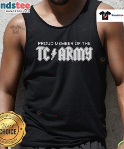 Tom Caron proudly wearing a TC Army metal tank top, showcasing team spirit and style in a vibrant setting.