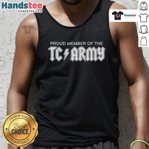 Tom Caron proudly wearing a TC Army metal tank top, showcasing team spirit and style in a vibrant setting.