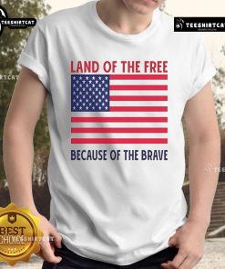 Vivek Ramaswamy smiling in a Land of the Free Because of the Brave T-shirt, promoting patriotism and freedom.