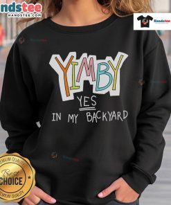 Alt Text: Cozy 'Nice Yimby Yes In My Backyard' sweatshirt displayed on a wooden table, perfect for casual wear and expressing support.