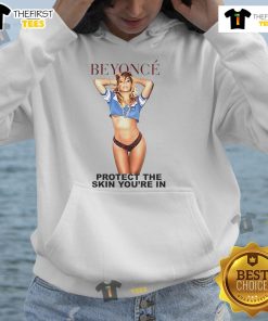 Alt Text: Beyonc wearing the official 'Protect The Skin You're In' hoodie, promoting skin positivity and self-love fashion.