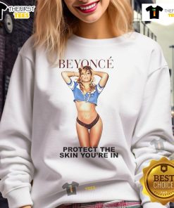 Beyonc wearing the official 'Protect The Skin Youre In' sweatshirt, promoting skin health and self-love.