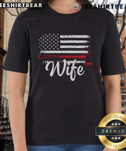 Official Firefighter Wife tee featuring America flag and fire axe design for proud firefighter spouses.