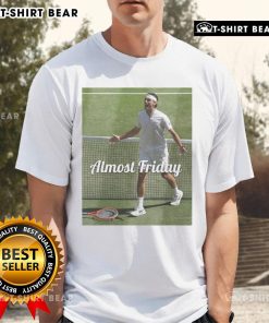 Alt Text: Official Fritz Wimbledon Almost Friday T-Shirt featuring a stylish design perfect for tennis fans and casual wear.