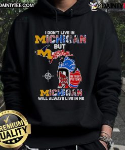 Cozy hoodie featuring 'I Don't Live in Michigan But Michigan Will Always Live in Me' design, perfect for Michigan fans.