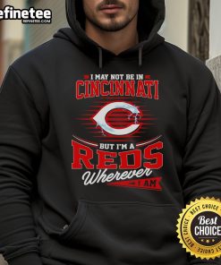 Official I May Not Be In Cincinnati But I Am A Reds Wherever I Am Hoodie displayed on a mannequin in a sporty setting.