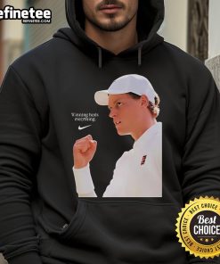 Alt Text: Jannik Sinner wearing the Nike X Wimbledon 2025 'Winning Heals Everything' hoodie on grass court.