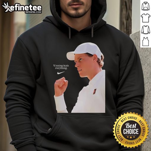 Alt Text: Jannik Sinner wearing the Nike X Wimbledon 2025 'Winning Heals Everything' hoodie on grass court.