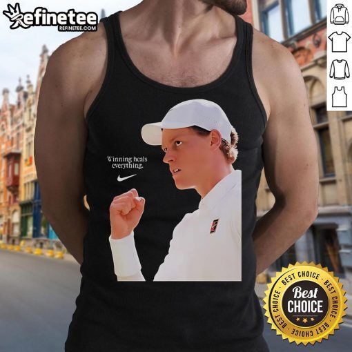 Alt Text: Jannik Sinner wearing the Nike x Wimbledon 2025 'Winning Heals Everything' tank top on grass court.
