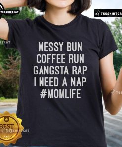 Mom wearing 'I Need A Nap' tee with messy bun, enjoying coffee during a busy day, perfect for mom life and casual style.