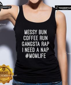 Mom wearing 'I Need A Nap' tank top, messy bun hairstyle, enjoying coffee, embodying mom life and gangsta rap vibes.