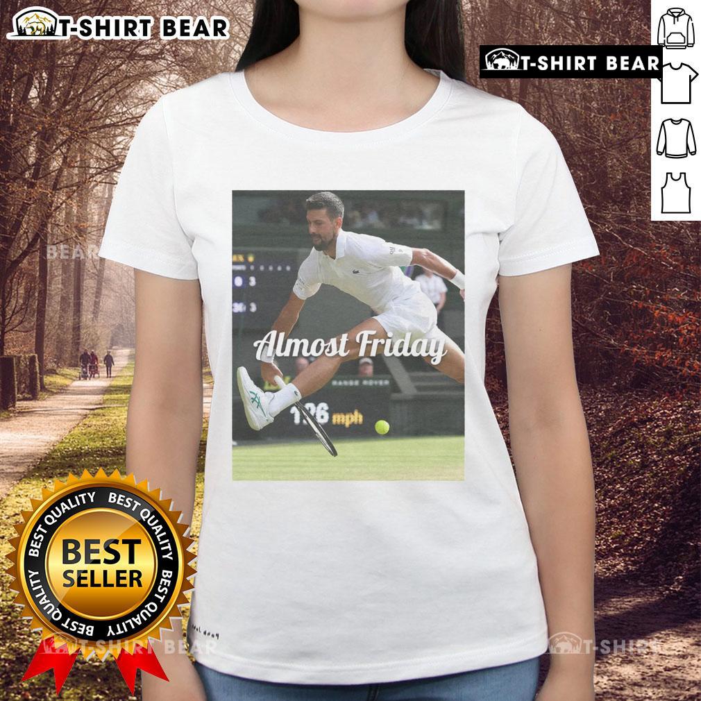Official Novak Djokovic Between The Legs Almost Friday Ladies Tee Official Novak Djokovic Between The Legs Almost Friday Ladies Tee featuring a stylish design for tennis fans.