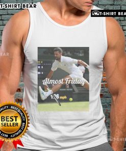 Novak Djokovic wearing a stylish 'Almost Friday' tank top, showcasing a trendy between-the-legs tennis pose.