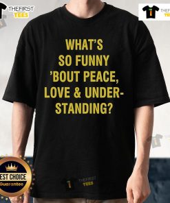 Official 'What's So Funny 'Bout Peace Love And Understanding' T-Shirt featuring bold graphic design and vibrant colors.