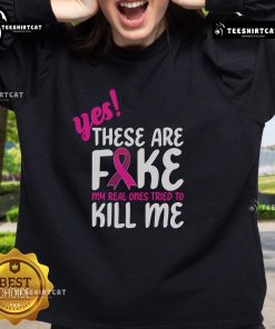 Stylish Breast Cancer Awareness sweatshirt with 'Yes, these are fake' slogan, promoting awareness and support for survivors.