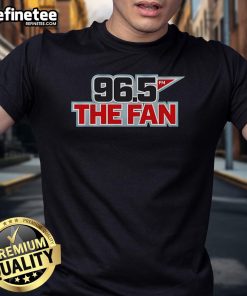 Alt Text: Original 96.5 The Fan Logo T-Shirt featuring a bold graphic design, perfect for sports fans and casual wear.