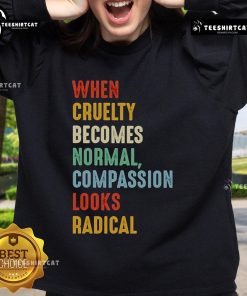 Original 'When Cruelty Becomes Normal, Compassion Looks Radical' sweatshirt displayed on a neutral background.