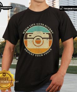 Vintage camera quote T-shirt: 'When Life Gets Blurry, Adjust Your Focus' design for photography enthusiasts.