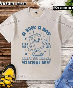 White washed t-shirt with 'A Book A Day Keeps The Mental Breakdown Away' printed in stylish font for book lovers.