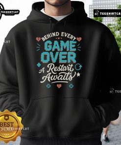 Pretty Behind Every Game Over A Restart Awaits Hoodie in vibrant colors, showcasing a stylish design for gamers.
