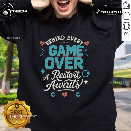 Cozy sweatshirt featuring 'Pretty Behind Every Game Over, A Restart Awaits' design, perfect for gamers and casual wear.