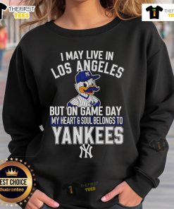 Cozy sweatshirt featuring 'I may live in Los Angeles, but my heart belongs to the New York Yankees' design.