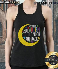Woman wearing a 'Love Someone With Autism To The Moon And Back' puzzle piece tank top, showcasing autism awareness.