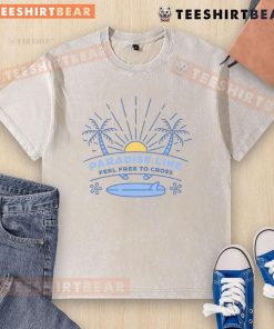 Pretty Paradise Line Feel Free To Cross washed t-shirt in vibrant colors displayed on a rustic wooden background.