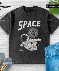 Pretty space astronaut exploring the universe on a washed t-shirt, perfect for cosmic adventure enthusiasts.