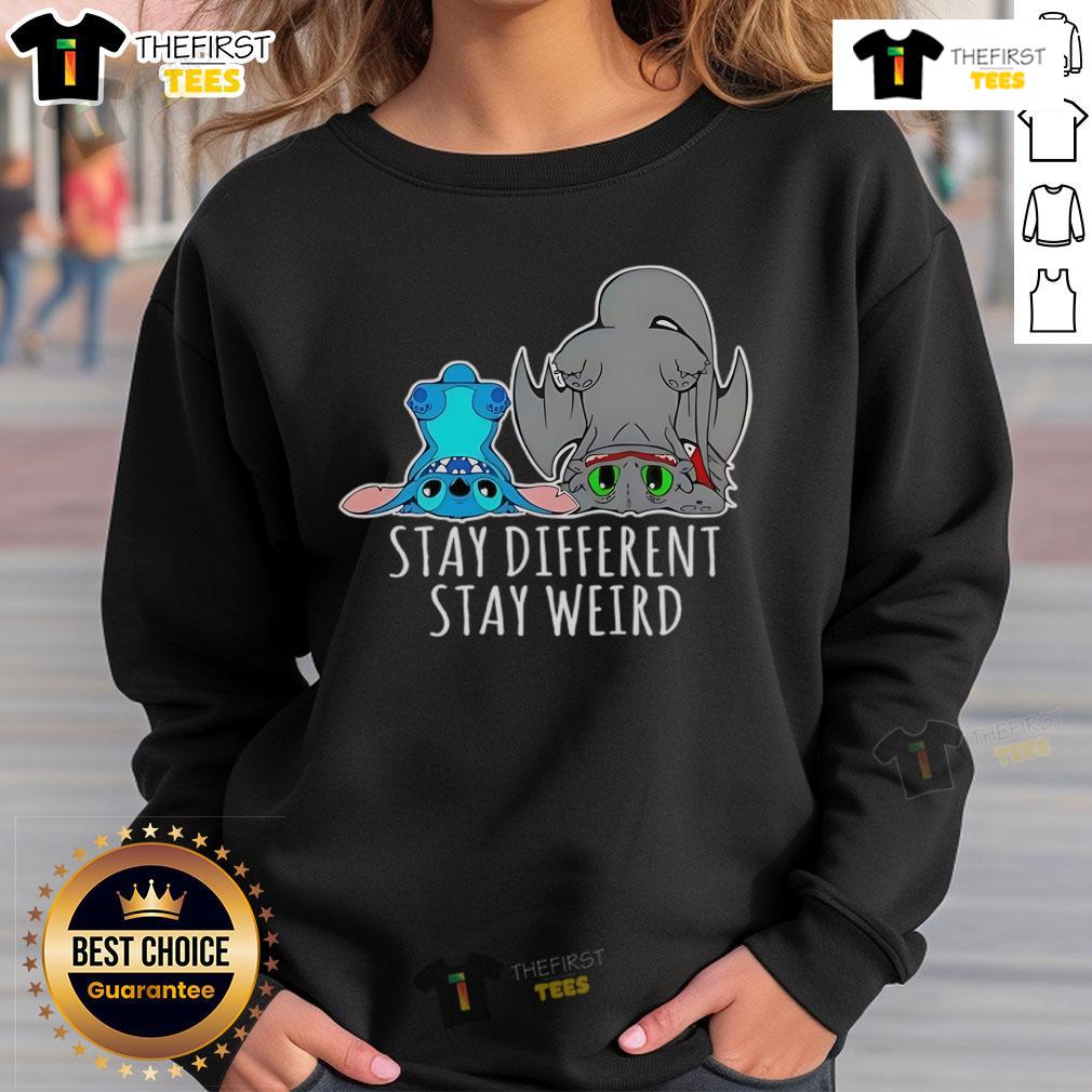 Pretty Toothless And Stitch Stay Different Funny Cartoon Sweatshirt Funny cartoon sweatshirt featuring a toothless character with stitches, showcasing a unique and playful design.