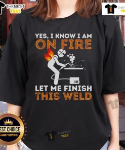 Pretty metal worker in a welding mask confidently finishing a weld, showcasing the 'Pretty Yes I Know I Am On Fire' tee.